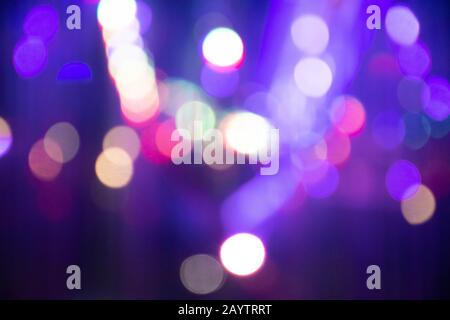 Abstract background with defocused bokeh colorful lights, glowing sparkling lights and reflections Stock Photo
