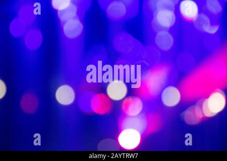 Abstract background with defocused bokeh colorful lights, glowing sparkling lights and reflections Stock Photo