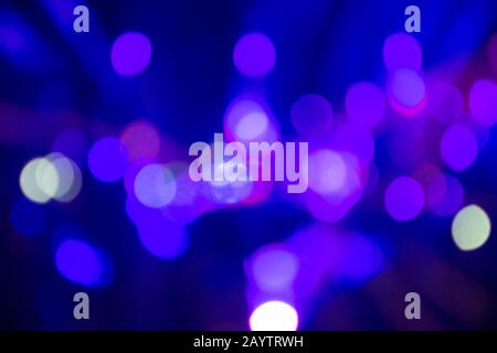 Abstract background with defocused bokeh colorful lights, glowing sparkling lights and reflections Stock Photo