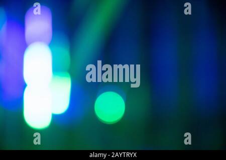 Abstract background with defocused bokeh colorful lights, glowing sparkling lights and reflections Stock Photo