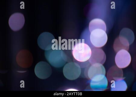 Abstract background with defocused bokeh colorful lights, glowing sparkling lights and reflections Stock Photo