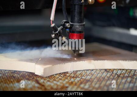 Cnc machine and wooden board in workshop, close-up Stock Photo