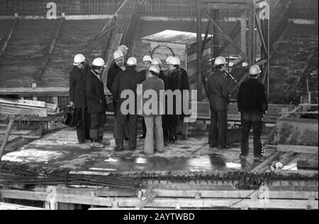 01 January 1979, Saxony, Leipzig: The Gewandhauskapellmeister Kurt Masur (3rd from left) visits the construction site of the New Gewandhaus in Leipzig on Karl-Marx-Platz at the end of the 1970s, accompanied by site managers and construction workers. Exact date of recording not known. Photo: Volkmar Heinz/dpa-Zentralbild/ZB Stock Photo
