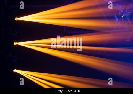 Scene, stage lights with colored spotlights and smoke, laser lights background, yellow and orange Stock Photo