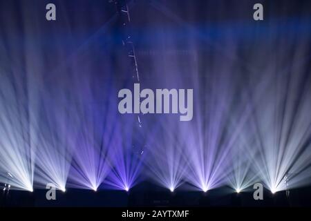 Scene, stage lights with colored spotlights and smoke, beams of lights background, white and blue Stock Photo