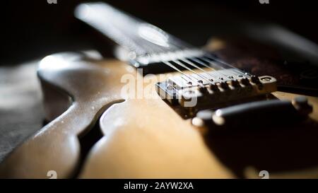 Vintage archtop guitar in natural maple close-up back light high angle view Stock Photo