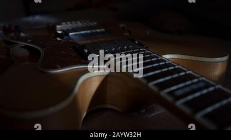 Vintage archtop guitar in natural maple close-up back light high angle view Stock Photo