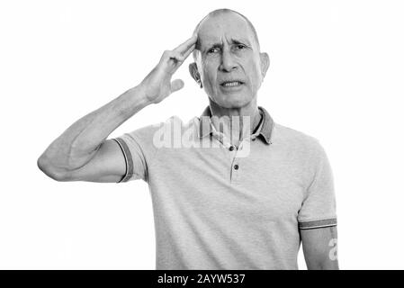 Portrait of stressed senior man having headache and looking tired Stock Photo