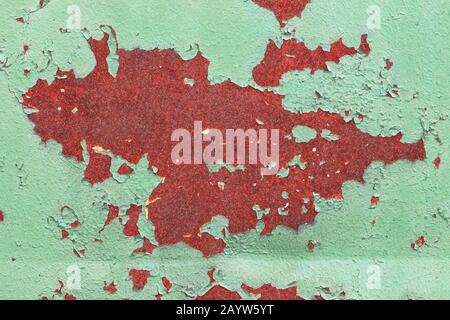 Top view close up on a sheet of old rusty metal with green peeling paint. Abstract rusty texture background Stock Photo