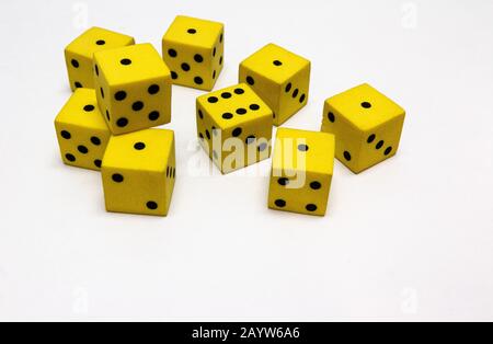 yellow and black dice on a white background Stock Photo