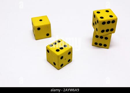 yellow and black dice on a white background Stock Photo