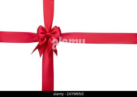 Beautiful red silk bow on a red ribbon tied with a cross isolated on white background Stock Photo