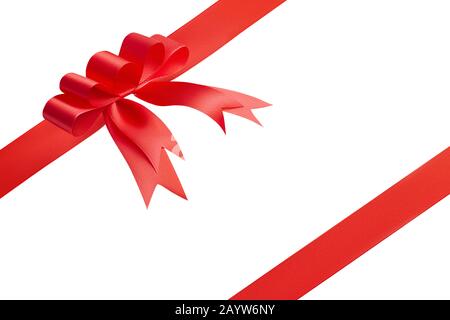 Festive composition for design from an unusual creative fashionable red bow and two red satin ribbons located at the corners of the picture Stock Photo