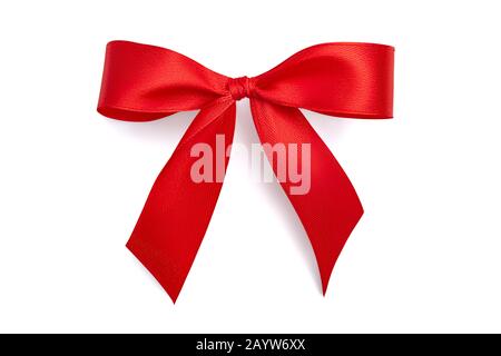 Flat lay simple holiday gift bow made of bright red shiny satin ribbon with a light gray soft shadow isolated on white background Stock Photo
