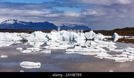 Panoramical view of Fjallsarlon glacial lagoon. Icebergs and mountains in Vatnajokull National Park, southeast Iceland, Europe. Landscape photography Stock Photo