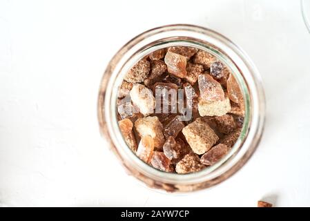 brown cane sugar lump in a sugar bowl, top view. Concept diet, junk food, health, lifestyle. Stock Photo
