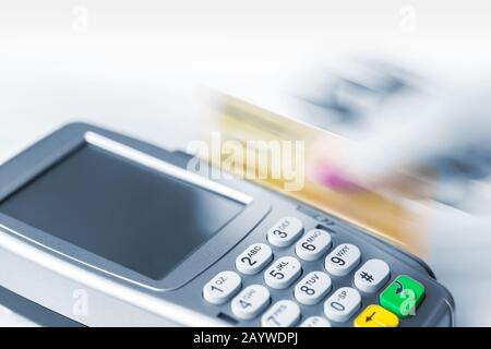 Payment by credit card with a magnetic strip. Movement, dynamics. Stock Photo