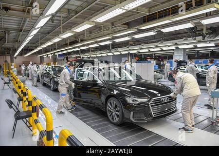 (200217) -- CHANGCHUN, Feb. 17, 2020 (Xinhua) -- Workers examine newly assembled Audi A6 L cars at a workshop of FAW-Volkswagen Automobile Co., Ltd. in Changchun, northeast China's Jilin Province, Feb. 17, 2020. A batch of black-colored Audi A6 L cars rolled off the production line on Monday. As the first batch of new cars produced at the FAW-Volkswagen Changchun base after the outbreak of novel coronavirus, it marked that the FAW-Volkswagen Automobile Co., Ltd., a passenger car joint venture between FAW and Volkswagen AG, officially resumed production. With thorough epidemic prevention an Stock Photo