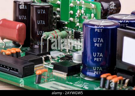 Resistors, capacitors and other electronic components of micro chip inside the computer close up. The world of electronics. Stock Photo