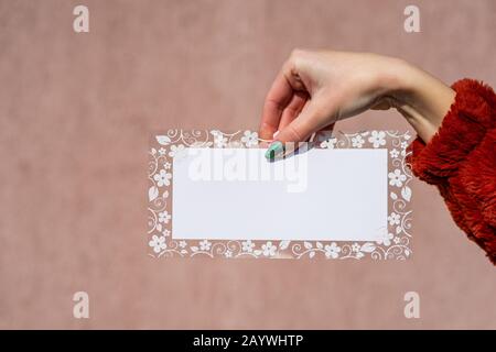 Empty space for text with decorated floral frame, greeting card design poster banner or ivitation . hand holding a blank sheet of paper. Rectangular t Stock Photo