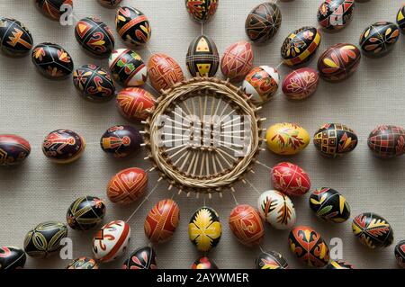 Easter composition - Pysankas (decorated eggs) and crafts made of straw. Kolomyia. Stock Photo