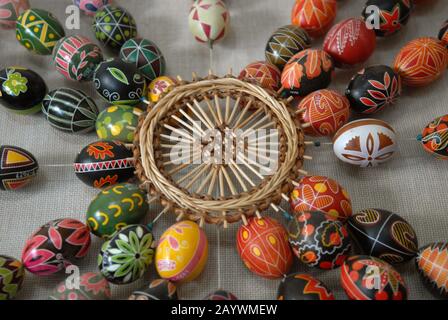 Easter composition - Pysankas (decorated eggs) and crafts made of straw. Kolomyia. Stock Photo
