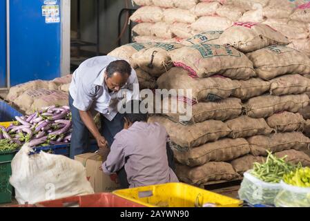 Dambulla, Sri Lanka: 18/03/2019: Largest fruit and vegetable market in Sri Lanka. Truck being loaded with various vegetables in sacks. Stock Photo