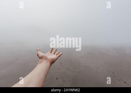Dense fog on ocean beach Stock Photo
