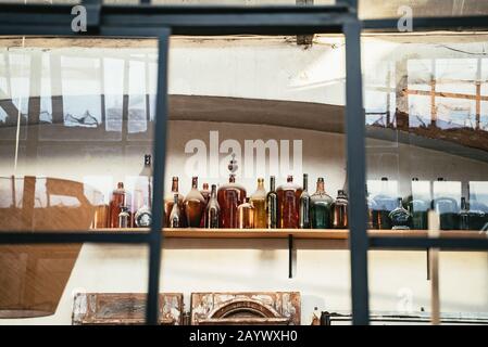 Array of assorted shapes of bottle on a shelf Stock Photo