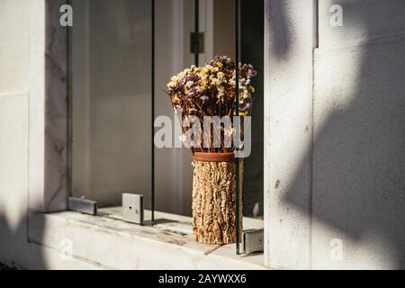 Arrangement of dried flowers in a wooden vase Stock Photo