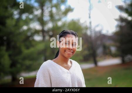 a portrait of an African-American teenaged girl outdoors