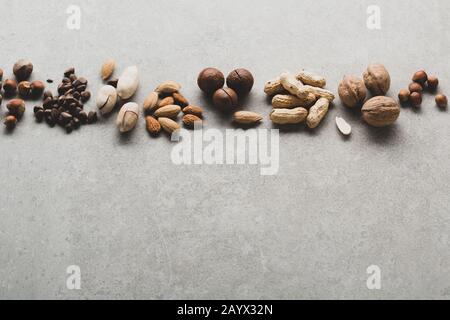 Pine nuts and pecan on gray background, healthy nuts Stock Photo