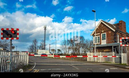 A closed gated railway level crossing at Whitehouse east of Middlesbrough Stock Photo