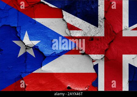 flags of Puerto Rico and UK painted on cracked wall Stock Photo