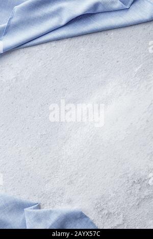 Gray concrete wall surface with frame from blue cloth up and down, textured background, copy space, place for text, top view Stock Photo