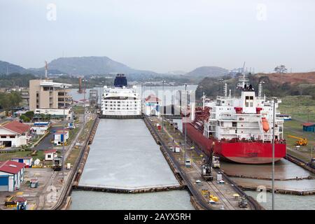 Cruise and cargo ships passing through the narrow canal before entering Panama City (Panama). Stock Photo