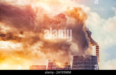 Air pollution smog from power factory plant chimneys smoking pipe sunset. Concept industry environmental problems Stock Photo