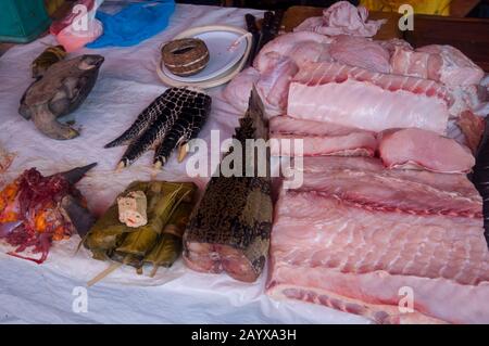 Caiman and turtle meat for sale on the market in in Belem, Iquitos, a city on the Amazon River in the Peruvian Amazon River basin. Stock Photo