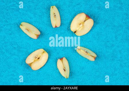 Sliced apples lie on a colored background, photo from above. Stock Photo