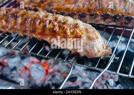 Pulling pork ribs grilled over the coals. Concept of food. Stock Photo