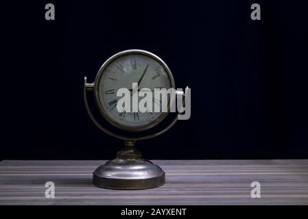 Close up vintage table clock on wooden background with copy space Stock Photo