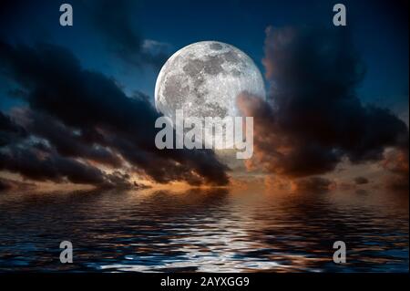 Magical evening on the sea. Big full moon reflection in water Stock Photo