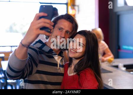 Friends taking selfies together Stock Photo