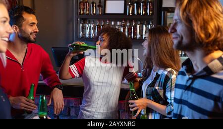 Friends having fun together while drinking Stock Photo