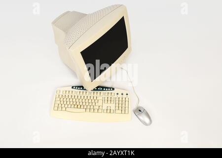 Old computer with keyboard and mouse on white background, seen from above Stock Photo