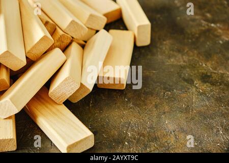 Scattering of wooden bricks on the old concrete floor Stock Photo