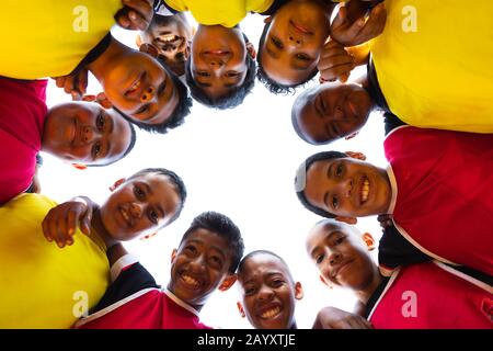 Low angle view of soccer team in circle Stock Photo