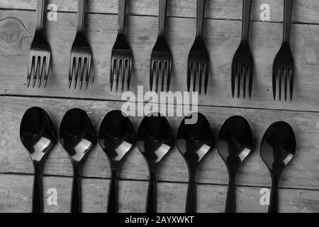 top view of plastic spoons and forks on wooden background Stock Photo