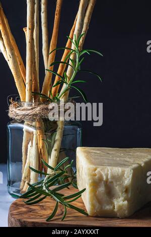 Grissini bread sticks and Asiago cheese. Stock Photo