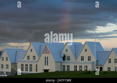 Rainbow over vernacular Iclandic houses in an overcast day Stock Photo